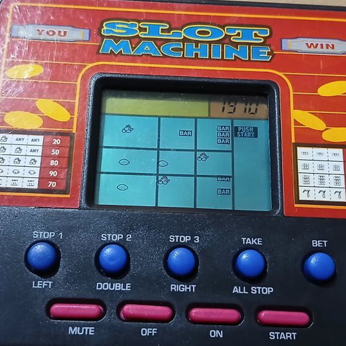 Vintage handheld electronic game slot machine like new