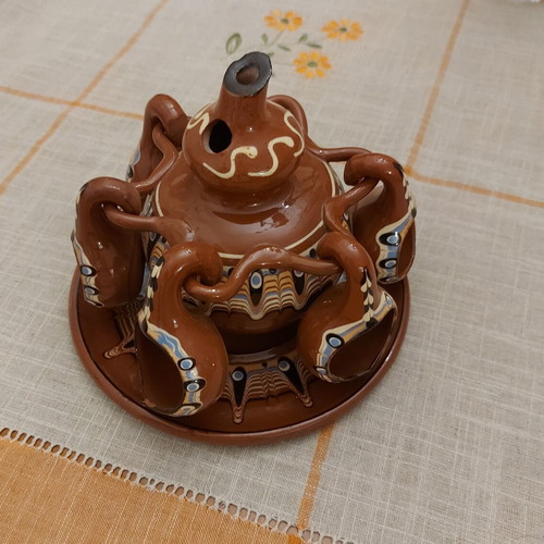 Decorative clay jug with glasses