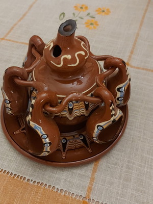 Decorative clay jug with glasses
