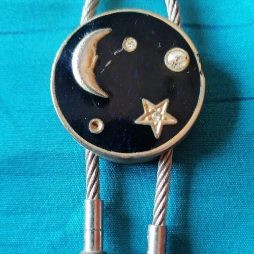 Keychain with moon and star design used, blue and silver