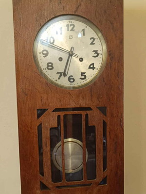 Antique Urgos wall clock used with pendulum and wooden frame