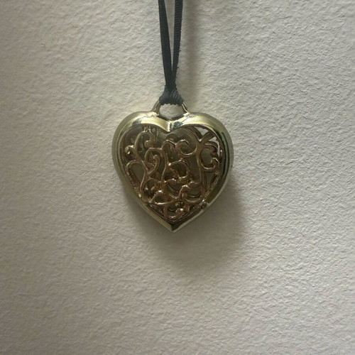 Long heart necklace with black cord like new, gold color