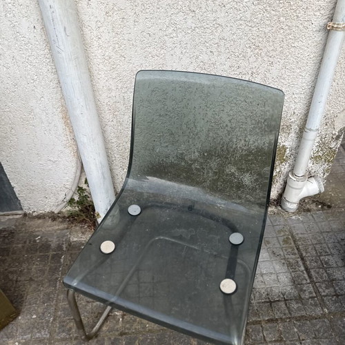 Transparent chair with tinted seat and chrome metal frame