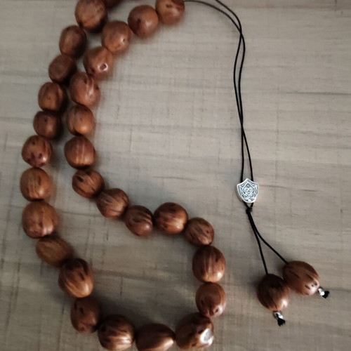 Handmade komboloi with nutmeg beads, silver shield