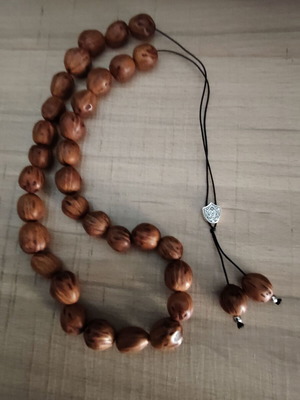 Handmade komboloi with nutmeg beads, silver shield