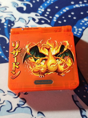 Gameboy Advance SP shell used, translucent orange matte with Charizard UV print
