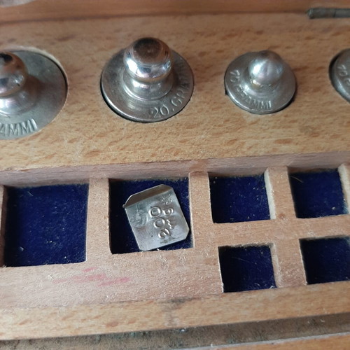 Wooden collectible box with cast iron weights