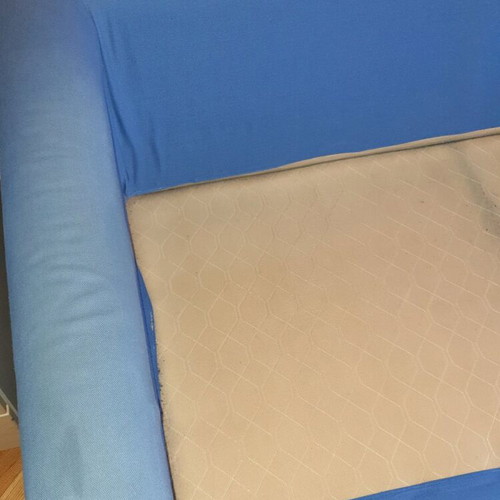Two-seater sofa used without two back cushions