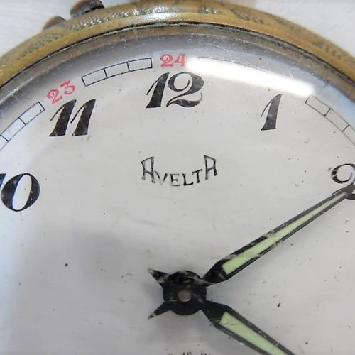 Old brass pocket watch with embossed design