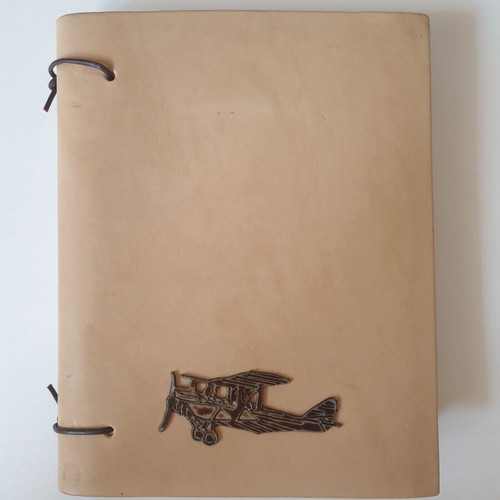 Handmade notebook with leather cover and metal airplane