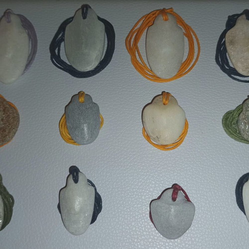 Collectible Cycladic idols, traditionally carved marble pendants