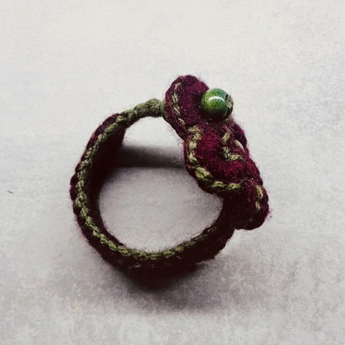 Handmade knitted bracelet with flower