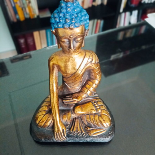 Golden ceramic Buddha statue sitting meditation decoration