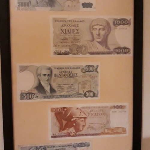 Collection of authentic Greek banknotes in frame with matte glass