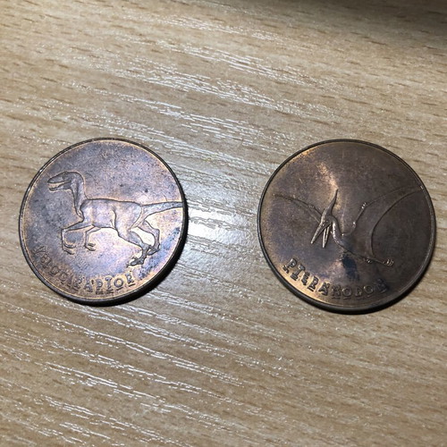 Jurassic World Tetley Velociraptor and Pteranodon coins, 38mm