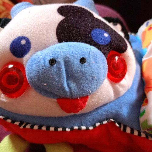 Cow toy for stroller or vintage rattle with sounds and textures