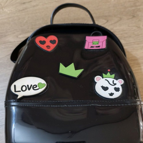 Small black backpack used with decorative patches