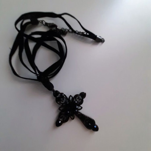 Black metal cross necklace like new with shiny stones on velvet ribbon