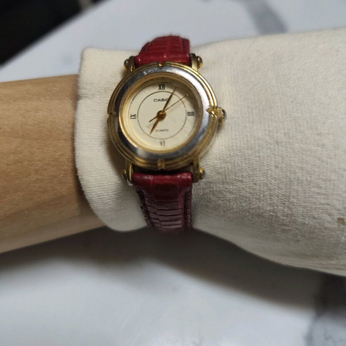 Casio LTP-1106 watch used, gold tone with red strap