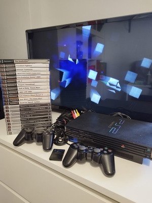 PlayStation 2 Fat console used with 2 controllers, memory card and 21 games