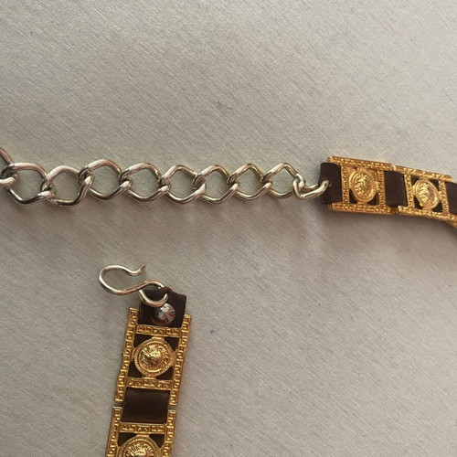 Belt with golden metal details on brown leather, like new