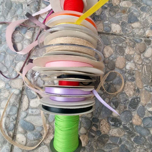 Wooden base with ribbons used for jewelry
