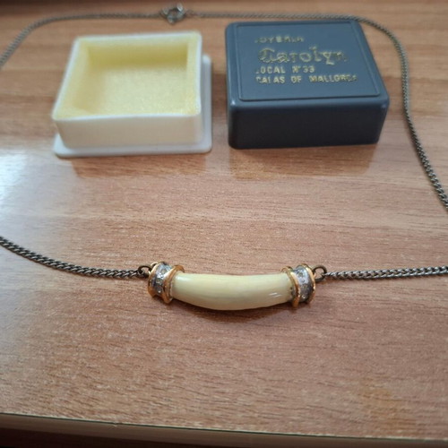 Necklace with ivory tusk pendant used, gold caps and strass decoration