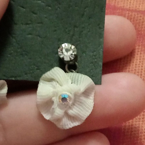 Fwo earrings with white fabric flowers and rhinestones hanging, unworn
