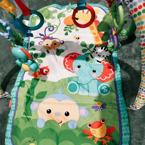 Fisher Price colorful activity gym for newborns used with extra toys