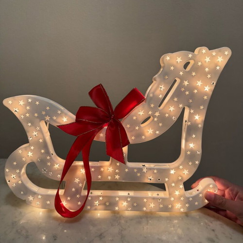 Christmas sleigh used with bow and light