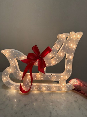 Christmas sleigh used with bow and light