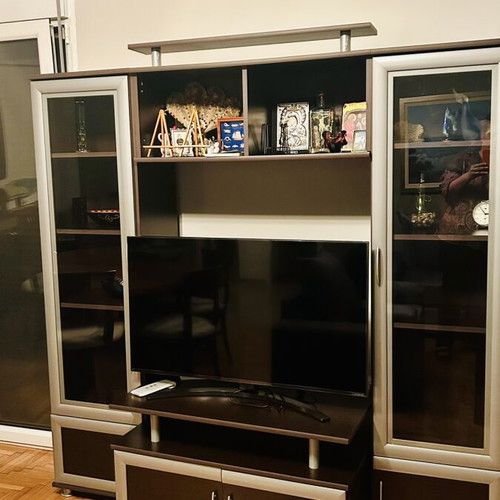 Living room unit like new with glass cabinets and TV space