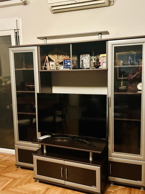 Living room unit like new with glass cabinets and TV space