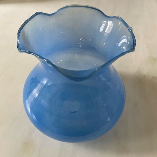 Flower vase used, very thin glass pale blue with wavy opening