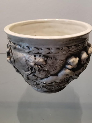 Faience cachepot used with embossed cherub design
