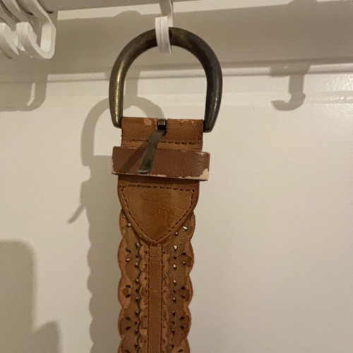 Tan belt like new with wavy edges and metal buckle