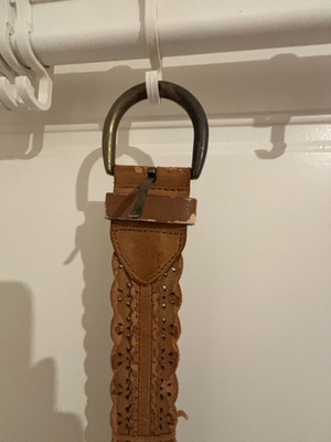 Tan belt like new with wavy edges and metal buckle