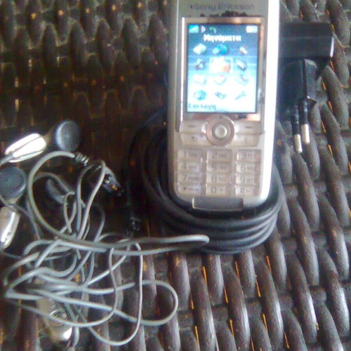 Sony Ericsson K700i used mobile phone with charger and headphones