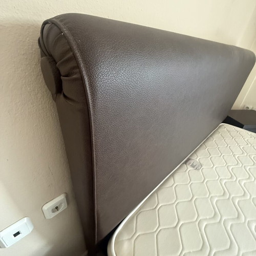 Double bed with brown leatherette upholstery, storage and lift mechanism