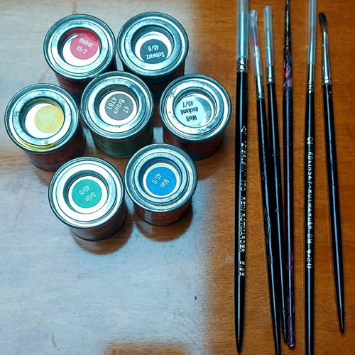 Various jars with colors and brushes