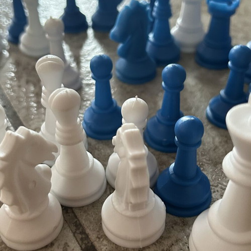 Vintage blue and white plastic chess pieces set