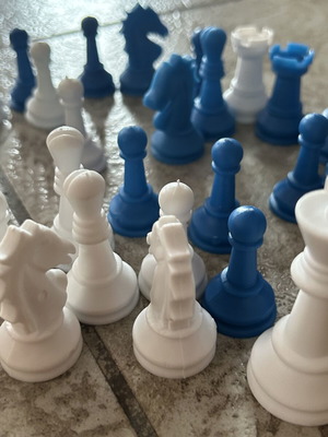Vintage blue and white plastic chess pieces set