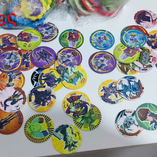 Various Pokémon and other collectible pogs