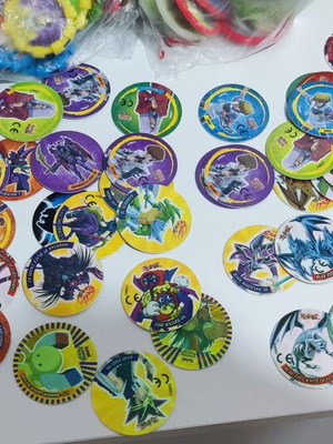 Various Pokémon and other collectible pogs