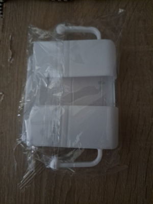 White wall-mounted plastic holder organizer for mobile phone or remote