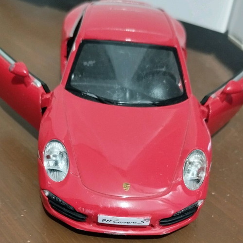Collectible Porsche Carrera toy car with opening doors like new