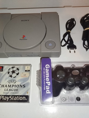 PlayStation 1 console with cables, game and new controller
