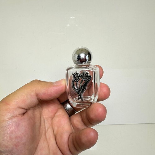 Vintage glass perfume bottle with metal tulip decoration
