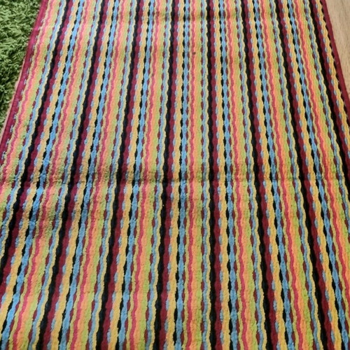 Runner rug used with stripes in bright colors