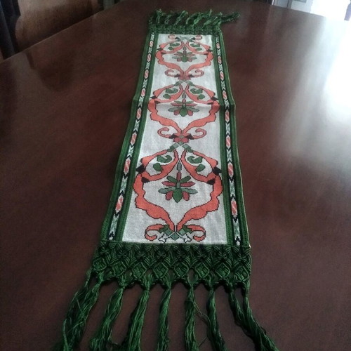 Handmade table runner with intricate crochet fringes and embroidery